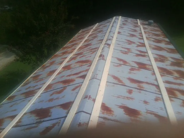 Rusted metal roof panels with new wood purlins before replacement — Storm Damage Roof Repair in Waterford by Roofing Brothers